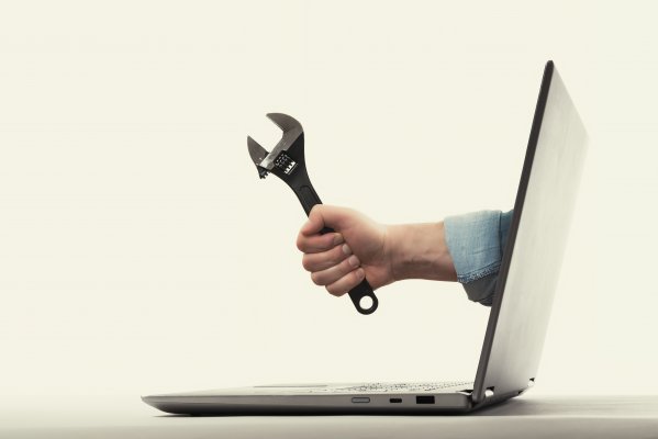 restoro system optimizers hand holding wrench coming out of laptop monitor